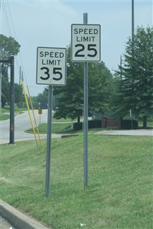 Two speed limit signs side by side showing contradictory limits of 25 and 35 mph