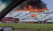 A caravan named Inferno engulfed in flames while being towed on a motorway